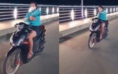 Video: Cô gái đi xe máy thả hai tay để "múa quạt" và "bắn tim" trên cầu Thạch Bích và cái kết